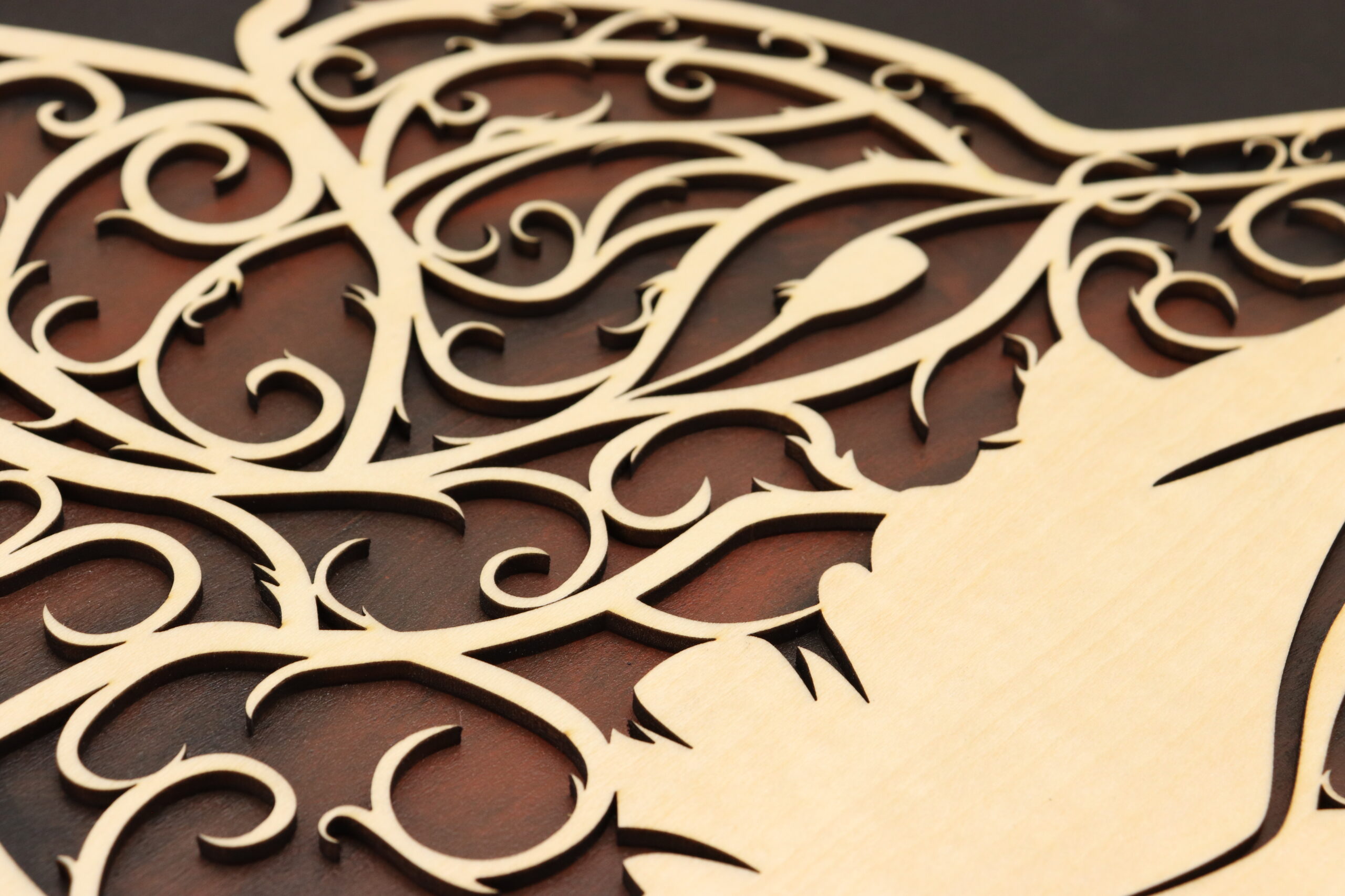 This close up of the fox door sign shows the intricate swirl details, highlighting the edge of the laser cut and the hand painted background done in black and fox red.