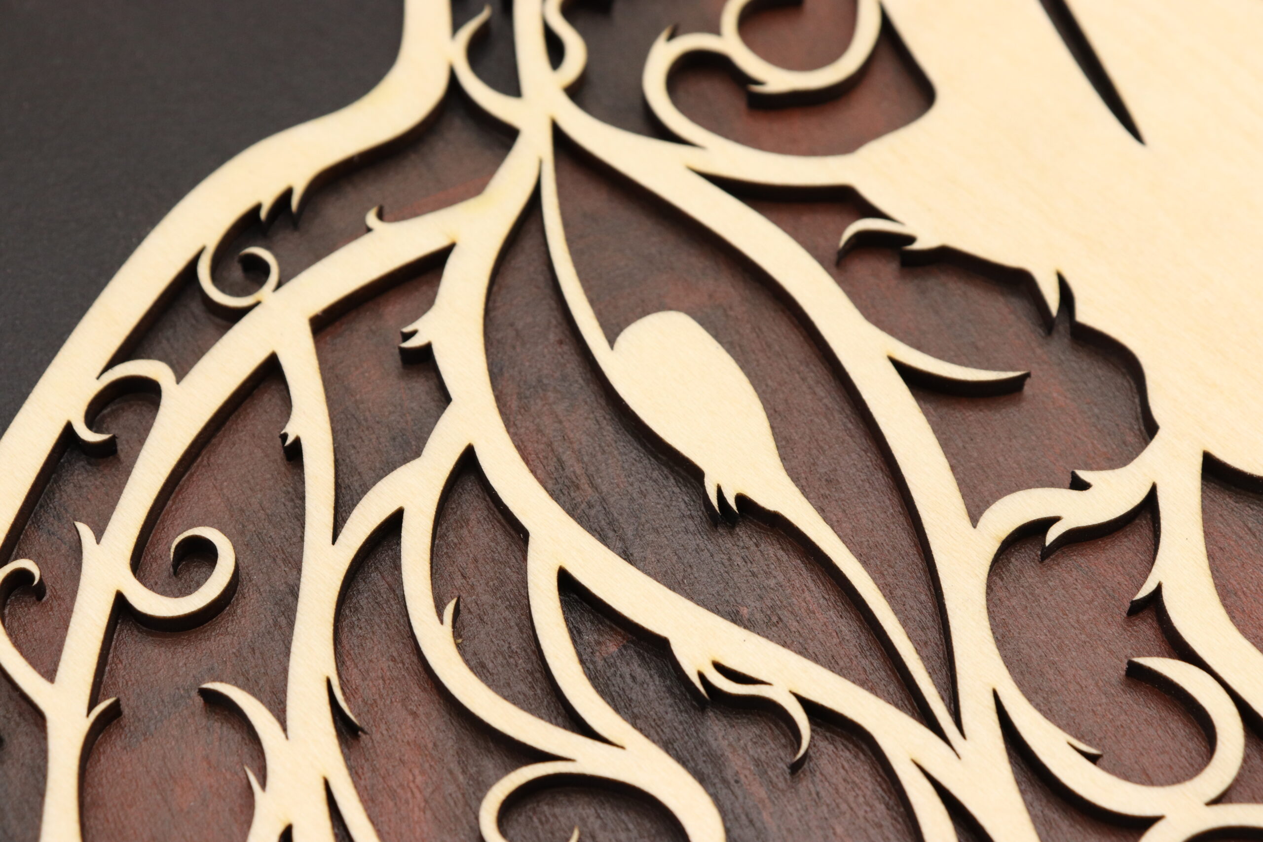 tjf26-0016 This close up of the fox door sign shows the intricate swirl details, highlighting the edge of the laser cut and the hand painted background done in black and fox red.